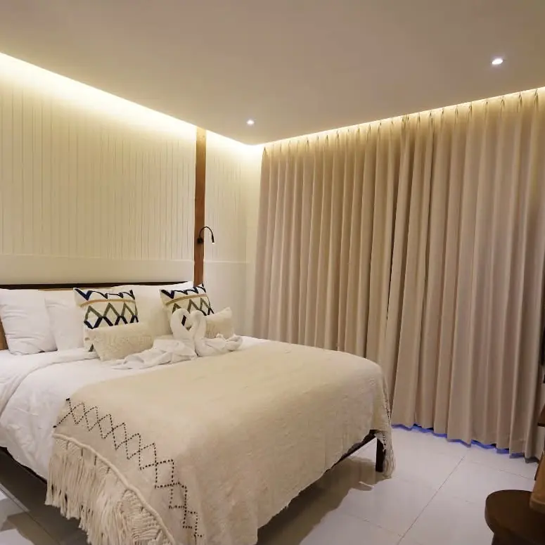 Second bedroom with a king bed, woven throw and timber accents