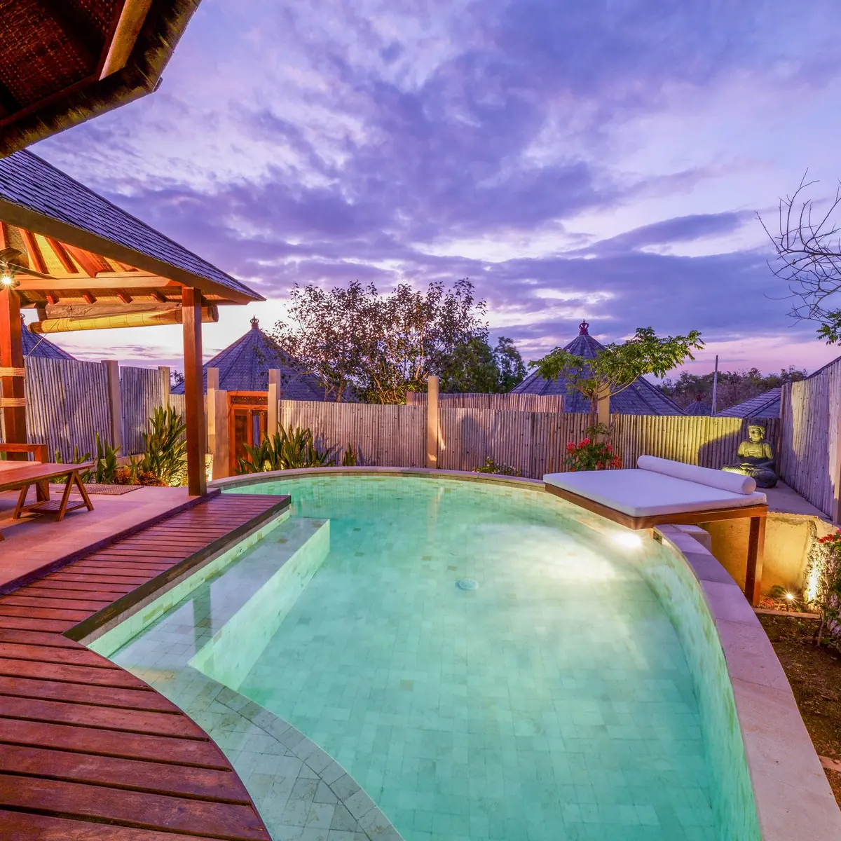 Timber pool deck and loungers at dusk