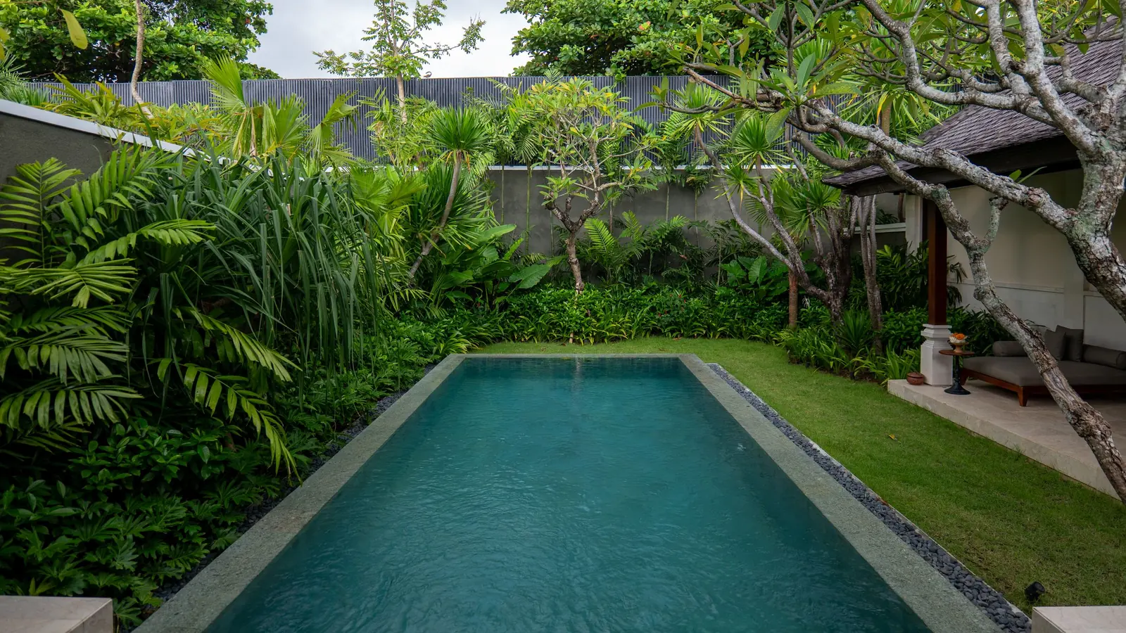 Private villa pool surrounded by tropical garden in Bali