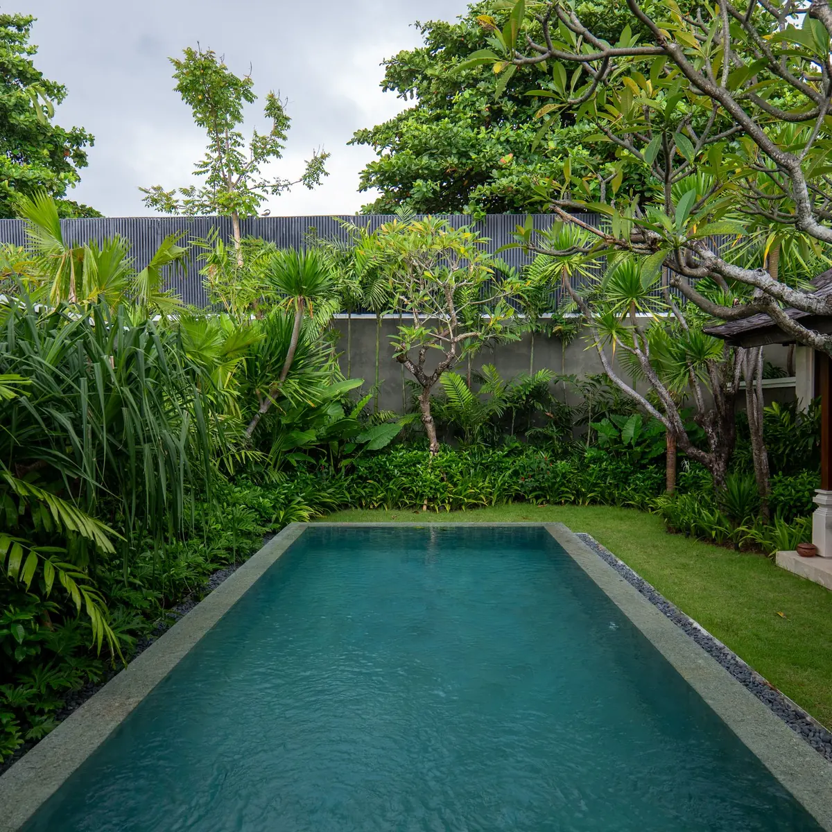 Private villa pool surrounded by tropical garden in Bali